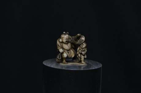Netsuke Hotei and boy ivory